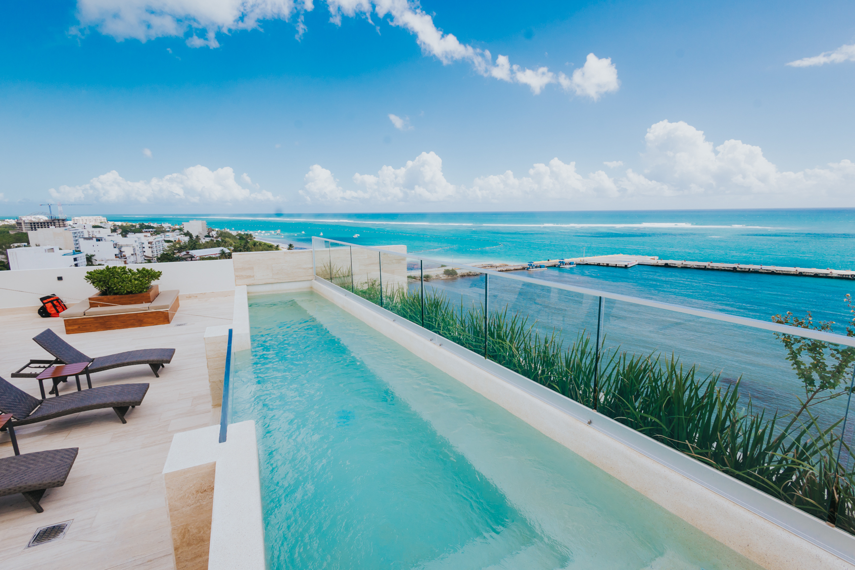 Rooftop pool terrace overlooking the turquoise Caribbean coastline